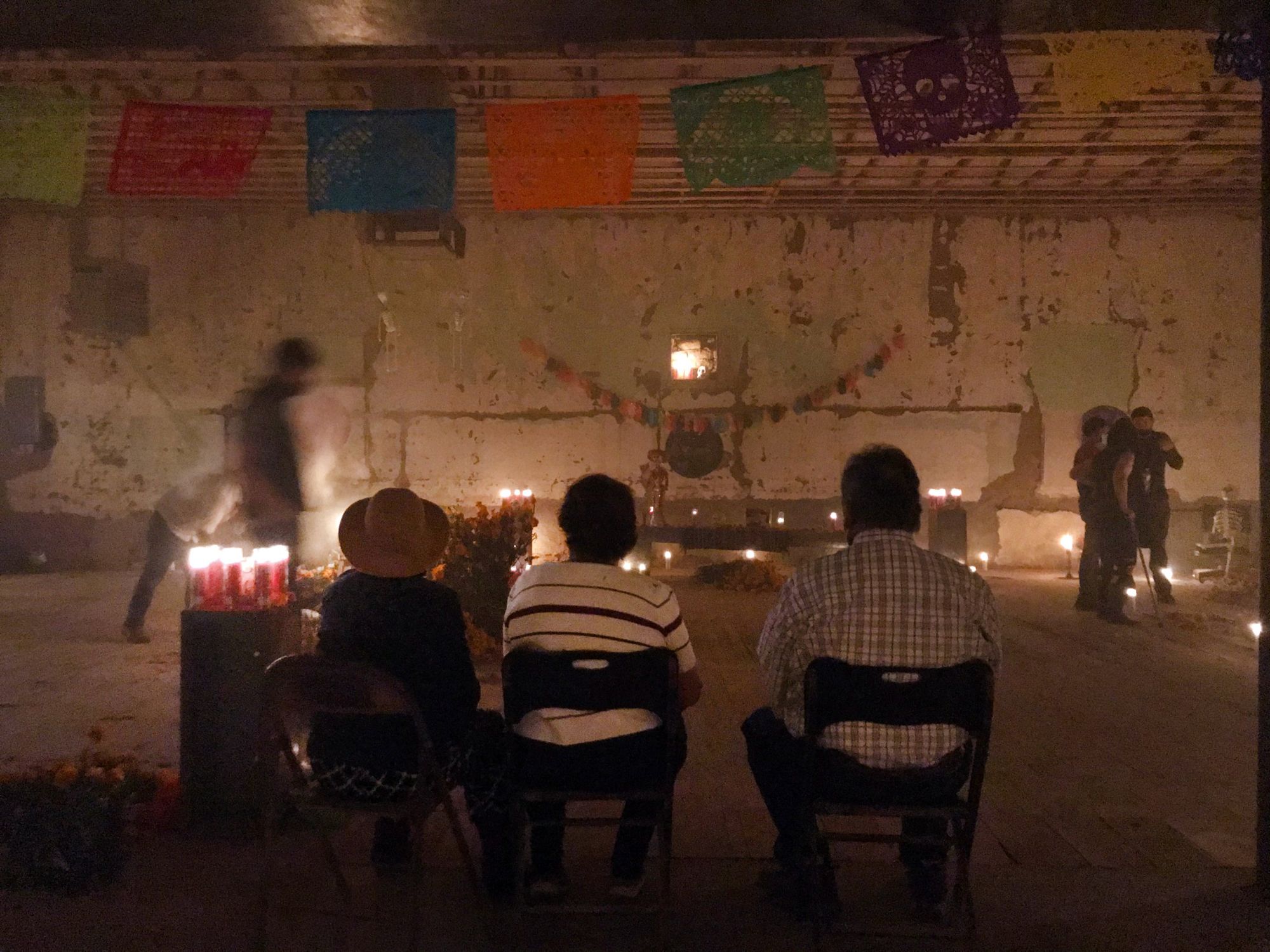 Visitors seated before the ofrenda, Herrera Building